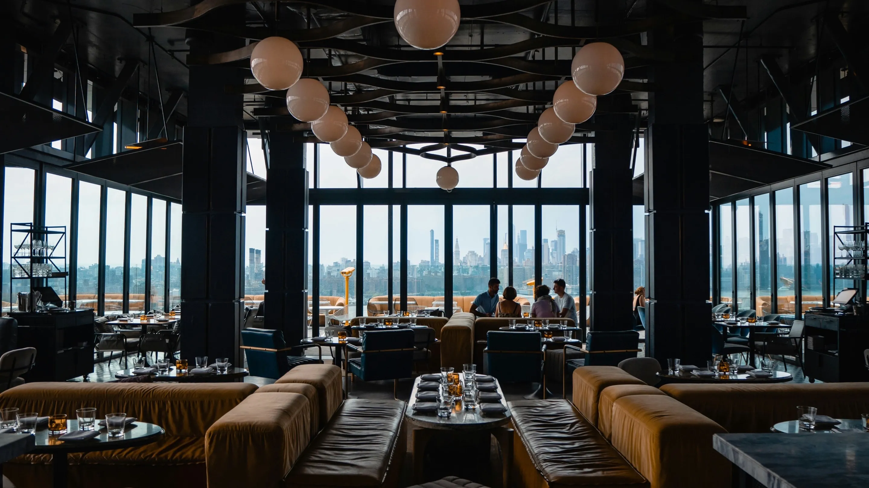 The FoodScan dining room at dusk, city skyline visible through floor-to-ceiling windows